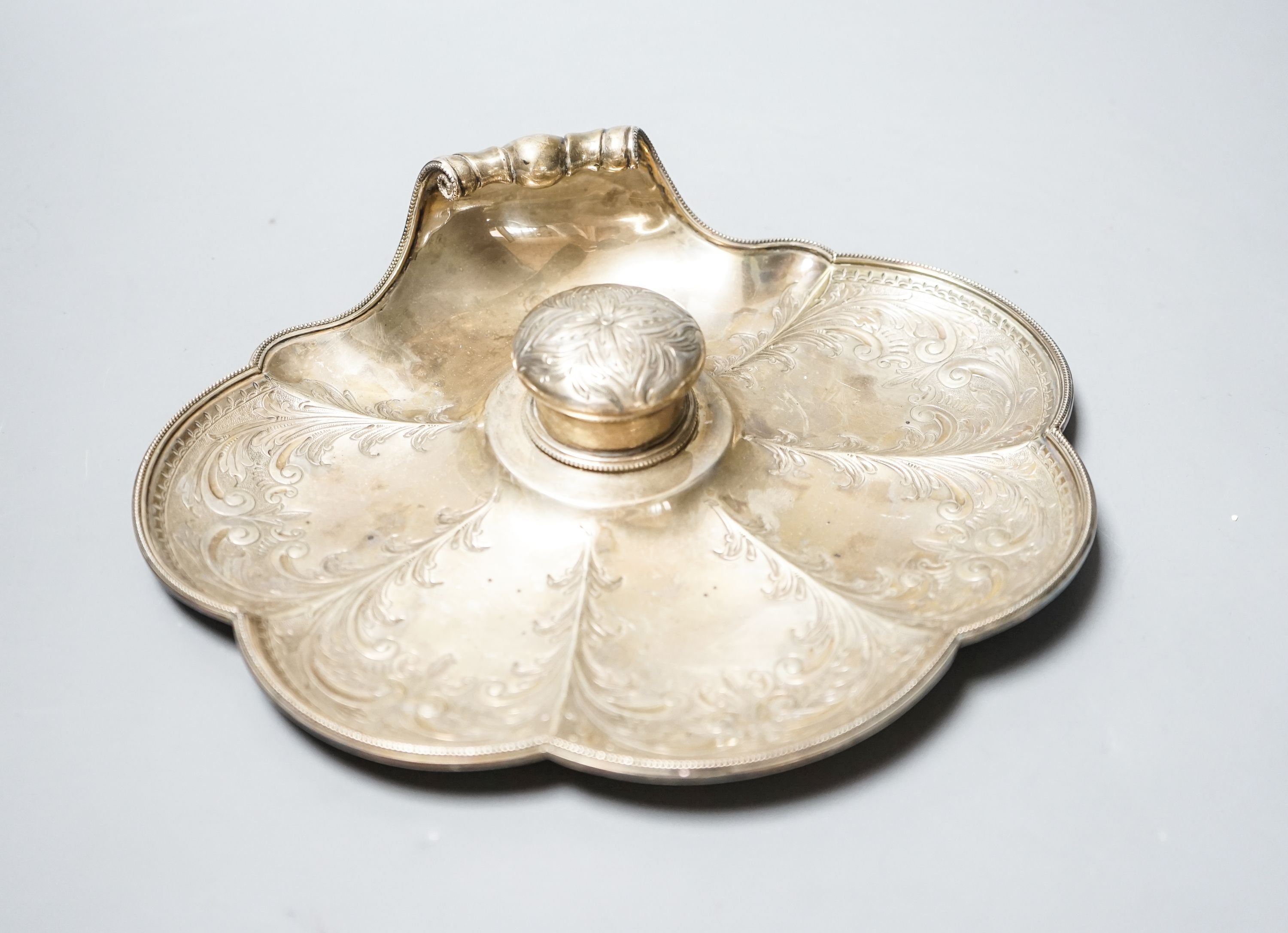 A late Victorian engraved silver shell shaped inkstand with single well, by Walker & Hall, Sheffield, 1897, 23.8cm, gross 14.5oz.